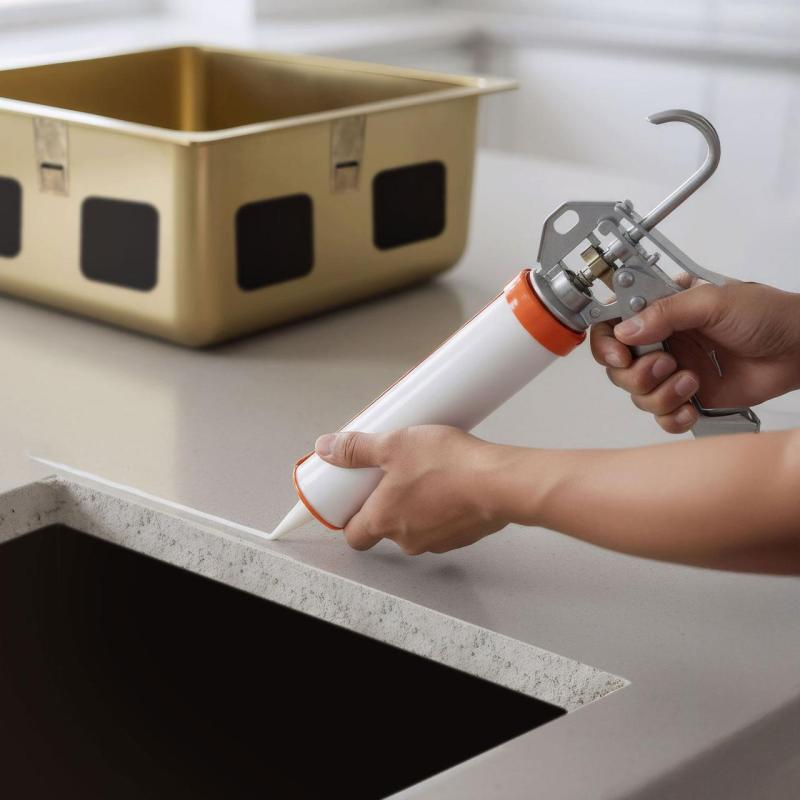 Acid-free silicone adhesive for undermount installation of stainless steel sinks